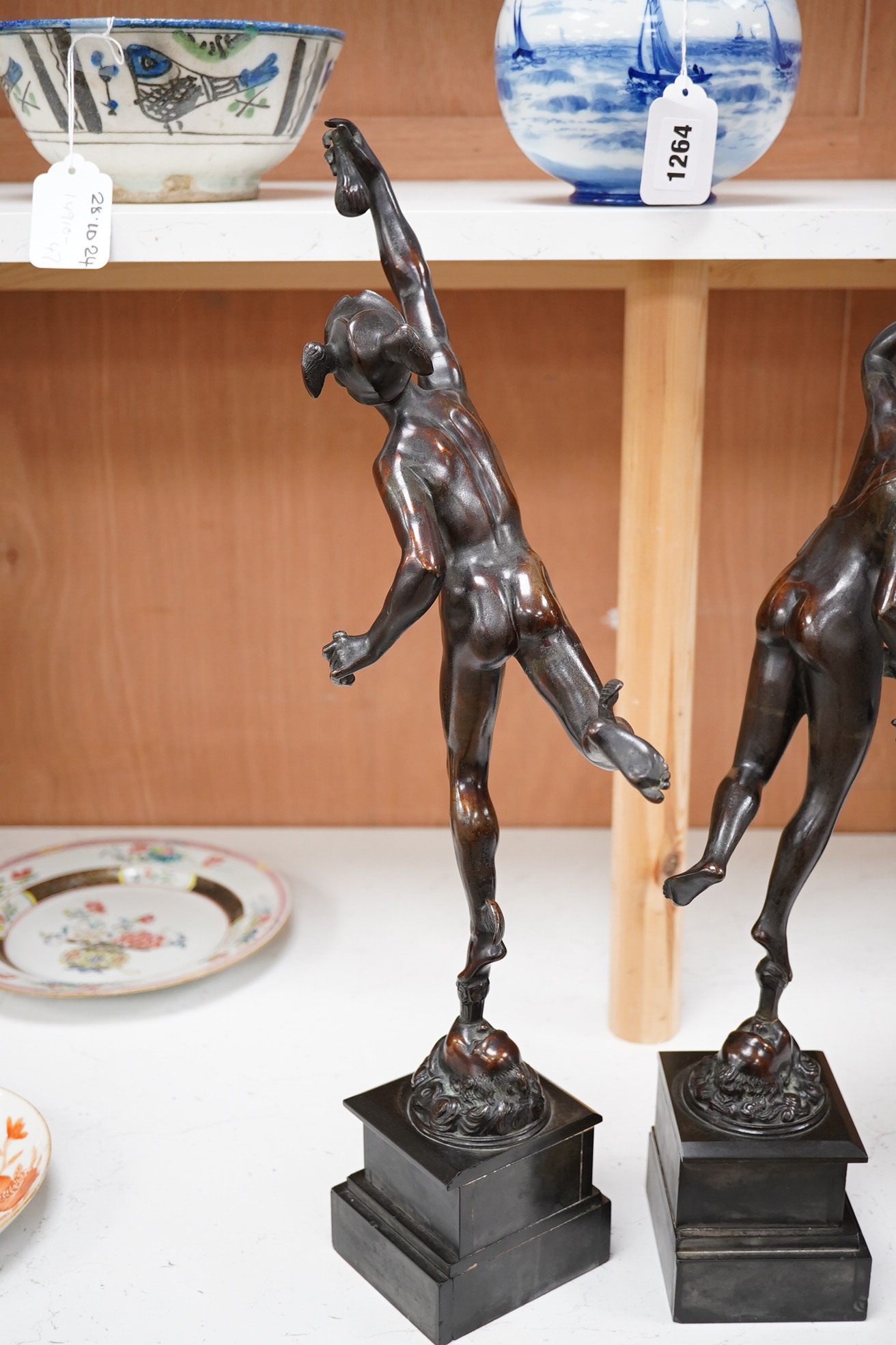 After the Antique, a pair of late 19th century bronze figures of Mercury and Fortune, each mounted on a black slate socle, with incised decoration, 51cm high. Condition - Mercury has his sceptre missing and Pheme has a b